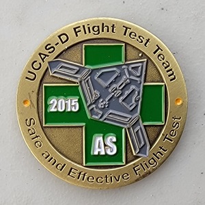 Custom Business Challenge Coin for N-UCAS FLIGHT TEST TEAM - GRAY, side 1. Features and context: Business Challenge Coin, Corporate Coin, Contractor.